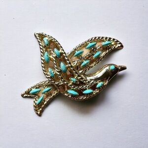 Bird pin, gold tone, pristine condition, designed to be worn as a pendant or pin
